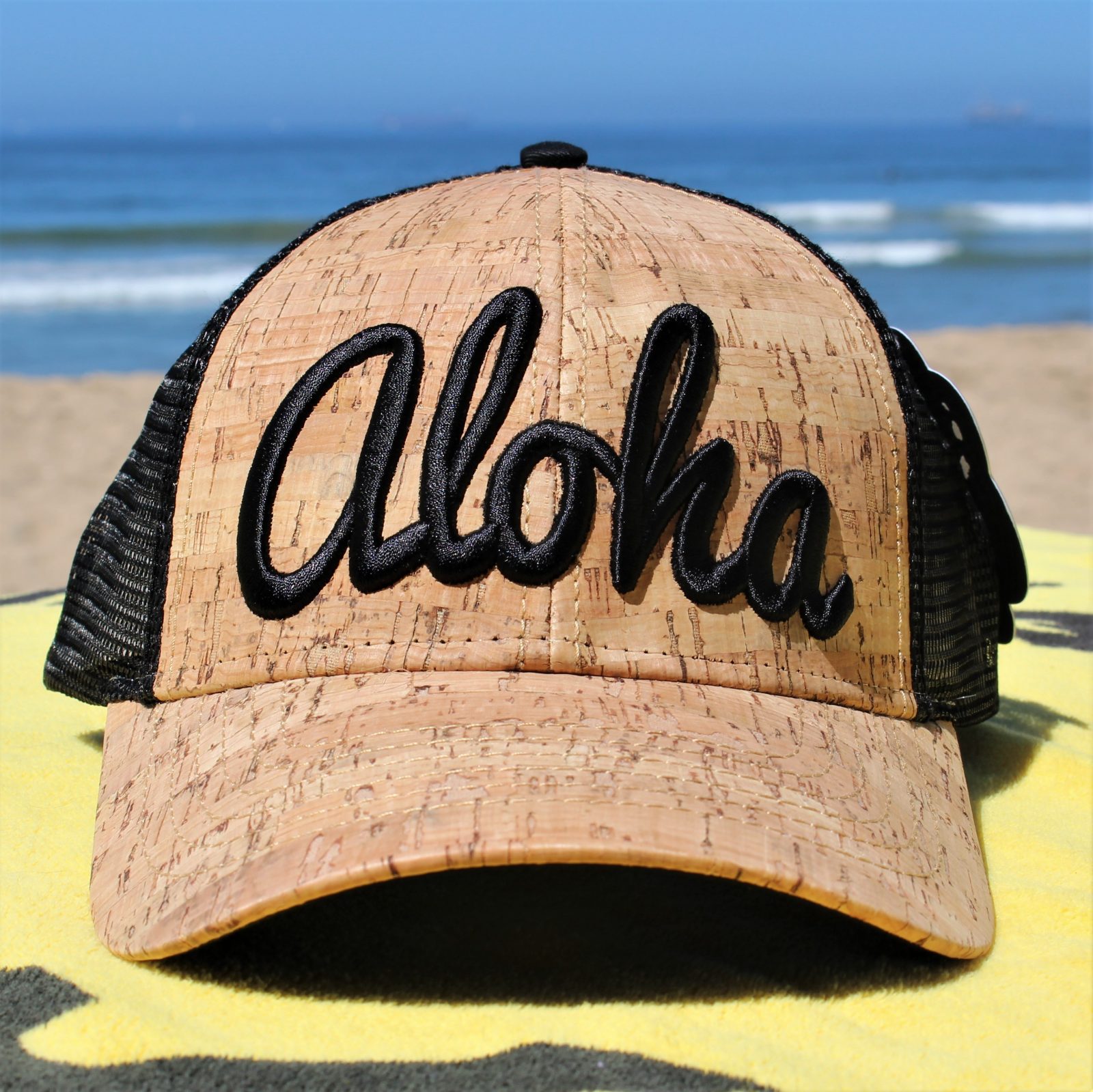 "Aloha" embroidered on Cork & Black Mesh Trucker Hat