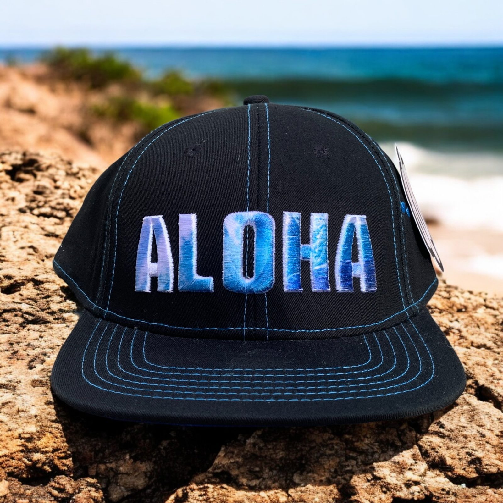 Black twill cotton blend hat with embroidered variated blue Aloha and Hawaiian Islands