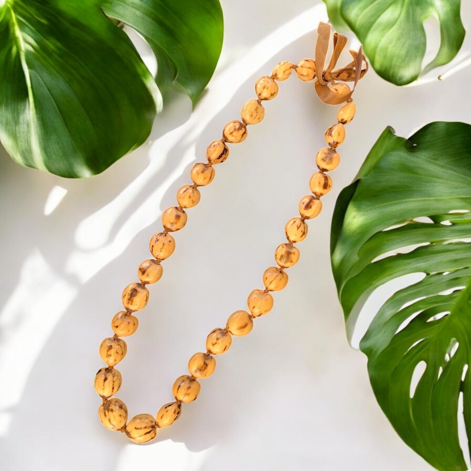 Kukui nut necklace blond 32 inches long with ribbon tie